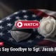 Fostoria News Memorial with American flag, white rose, and police badge for Sgt. Jacob Roesler.
